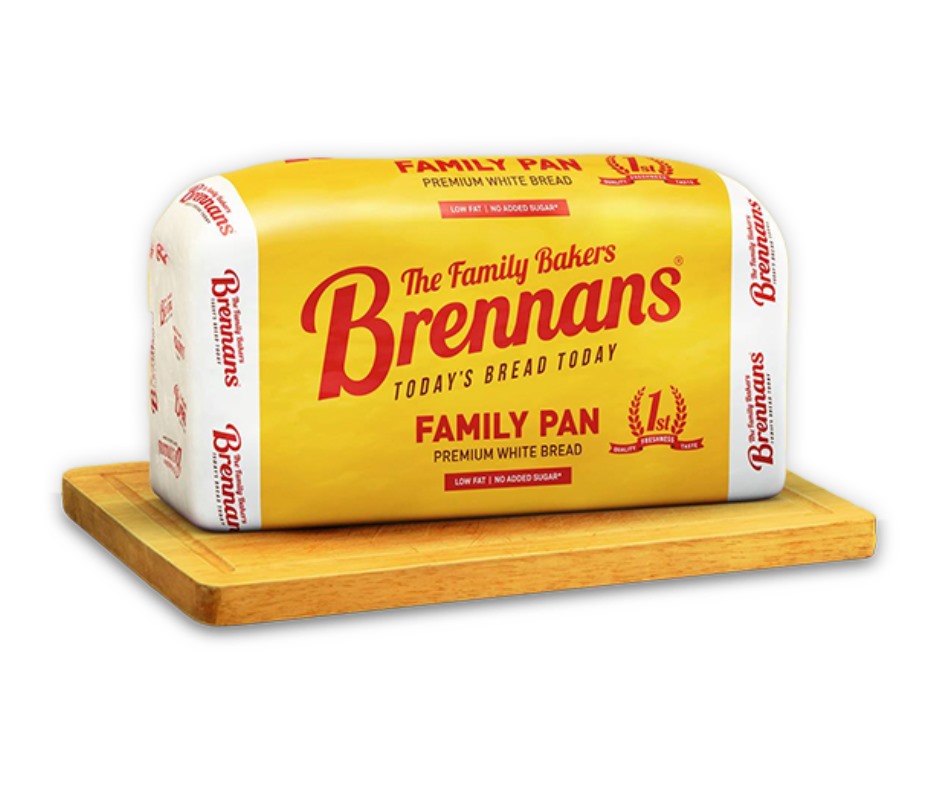 A loaf of Brennans Bread sitting on a wooden chopping board
