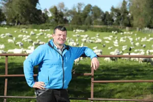 Brian Nicholson standing in green field