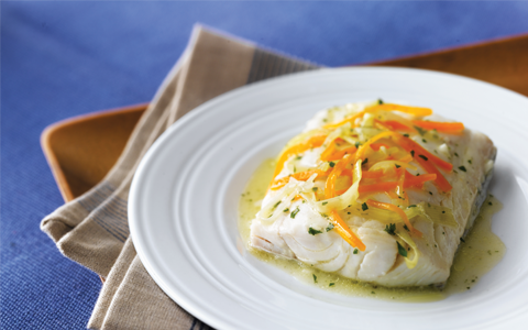 Steamed Haddock on plate with carrots and leeks