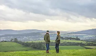 Two farmers standing on a field
