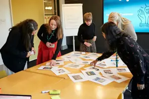 Bord Bia Insights team during a brainstorming session. All team members gathered around a table picking out images.