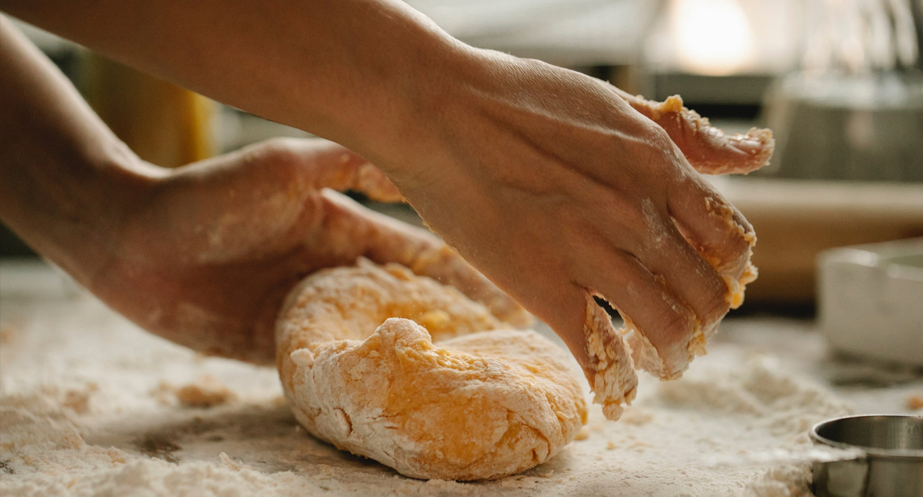 Hands making bread dough