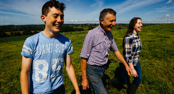 people walking through field